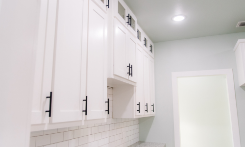 White cabinets with black hardware.